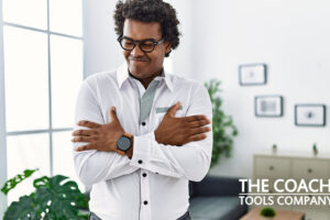 Man Hugging Himself in Office