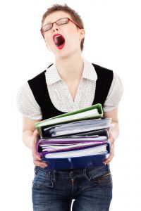Stressed woman with folders