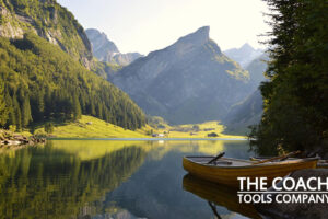 Stillness shown by mountain with lake, reflections and boat