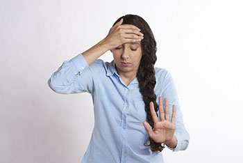 Stressed woman with hand on head