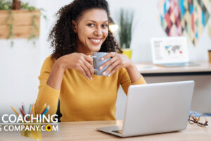 Coach thinking creatively at desk with mug