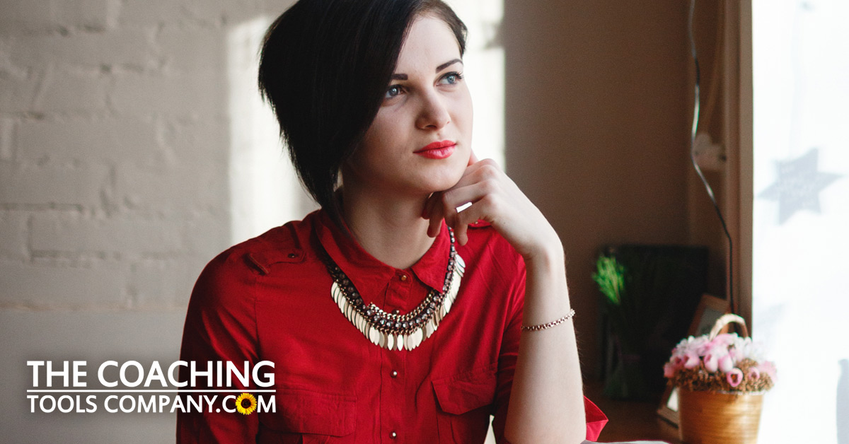Woman pondering critic in red dress in coffee shop