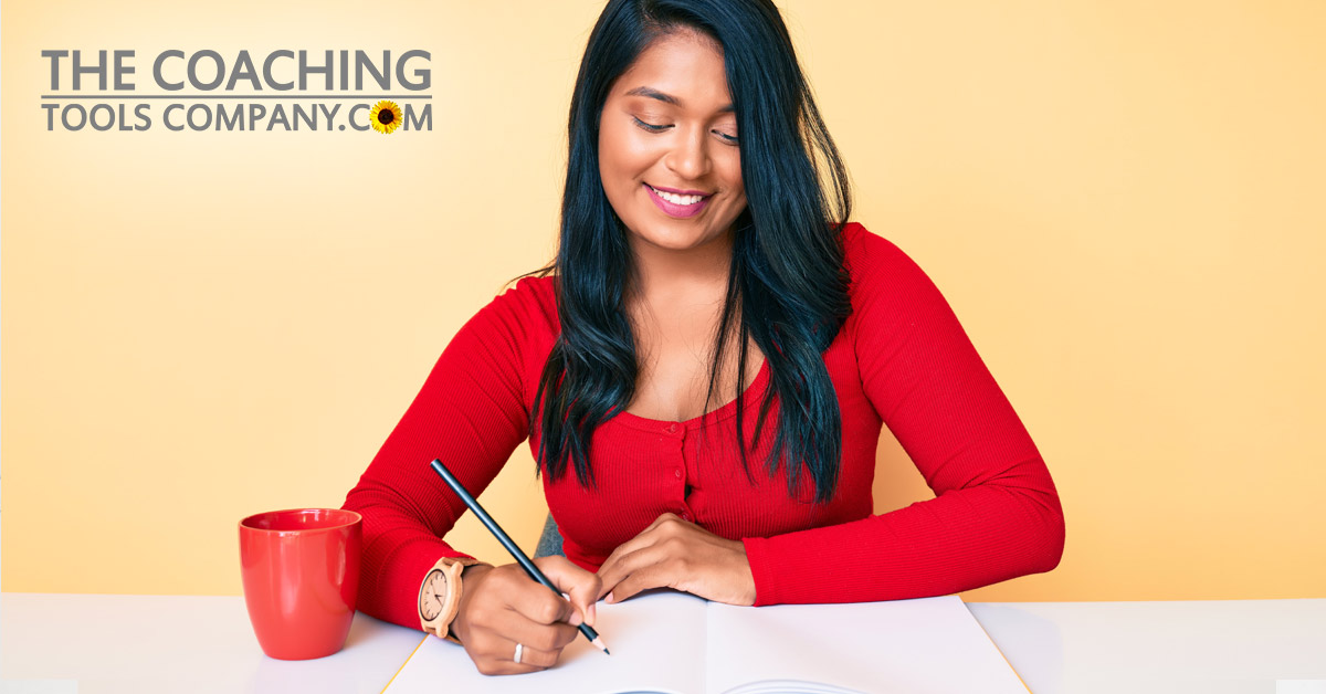 Woman Journaling for Success on Desk