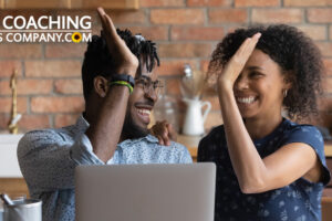 Coach and Client high-fiving in office