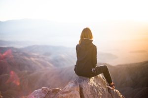 Woman at top of mountain looking at view