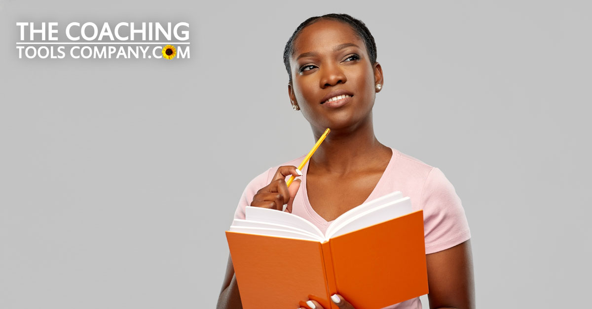 Intuition in Coaching - Coach pondering with notebook
