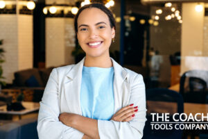 Confident Businesswoman in office with arms crossed smiling