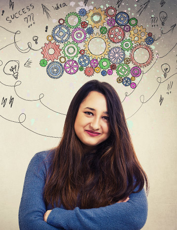 Woman using coaching tool of intuition with colourful cogs in brain shape above head